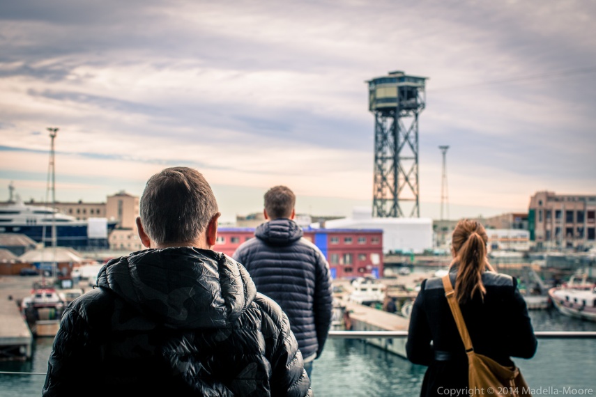 Three tourists looking out to a surreal scene at Mare Magnum, Port Vell, Barcelona