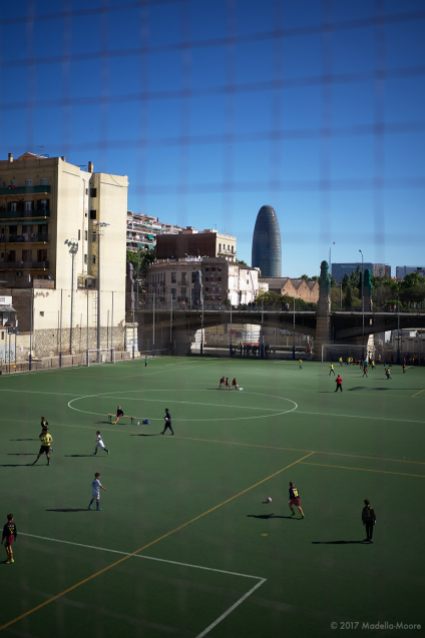 Torre Glòries, seen from a football ground in Fort Pienc, Barcelona.