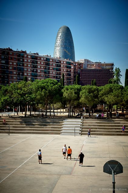 Torre Glòries, seen from the Parc del Clot, Barcelona. If everyone seems to be playing football around the tower, that might be because the tower's default colours are those of FC Barcelona...
